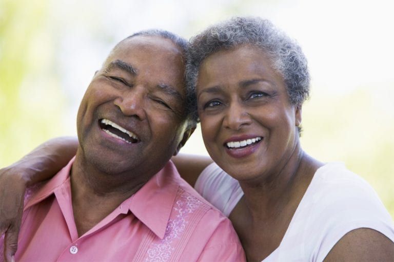 elderly black couple smiling