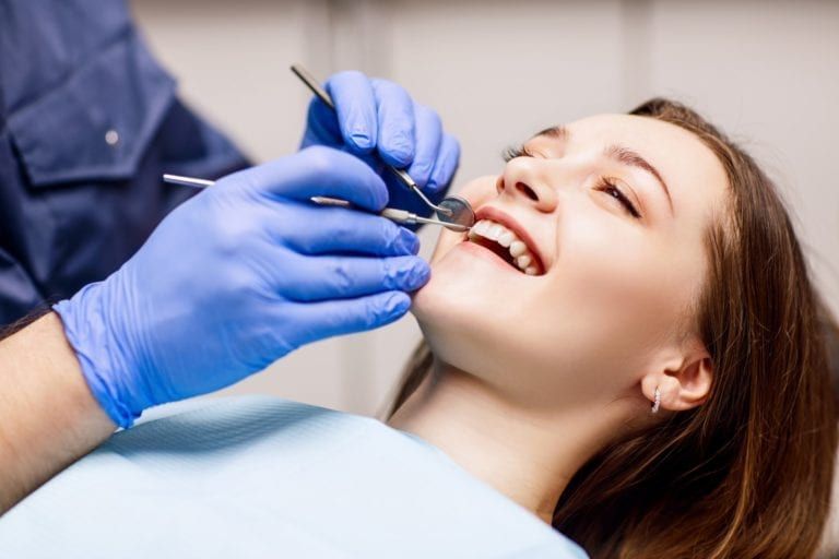 Female Patient Getting Teeth Cleaned