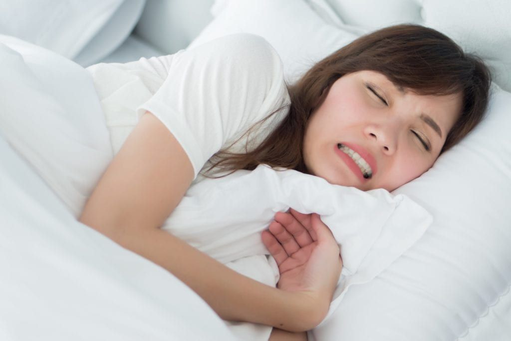 woman clenching her teeth in her sleep